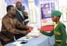 DGM, Human Resources & Admin, Dangote Cement Ibese Plant, McDappa Ngo (L); DGM, External Relations, Joseph B. Alabi presenting scholarship award to Miss Usman Yetunde Iyabode of Yewa Egbado College, Ilaro, Ogun State at Dangote Cement PLC presentation of scholarship award to Ibese indigenes in June 2014.