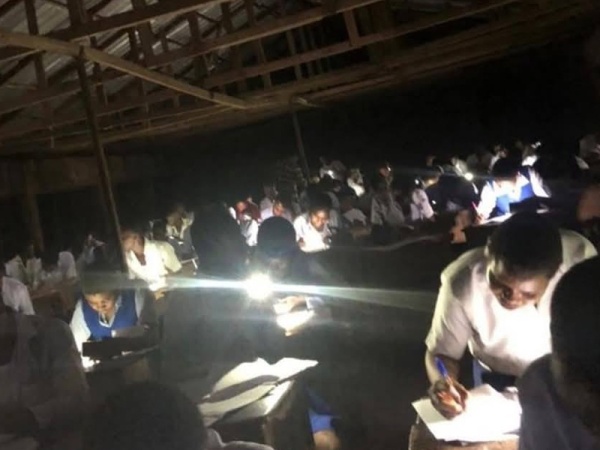 Outrage as WAEC candidates write exams using torchlights after hours-long delays